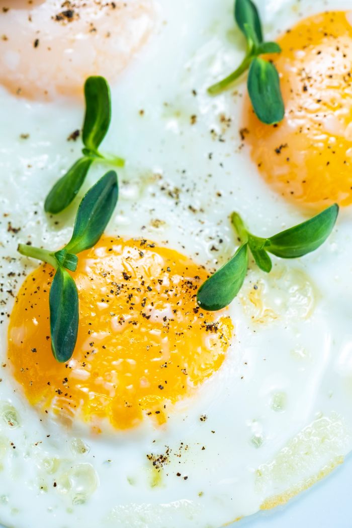 omelette topped with herbs and pepper