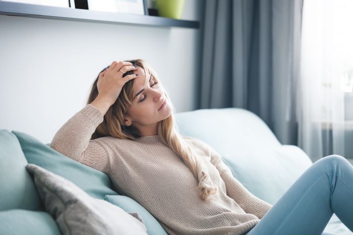 Sad,Woman,Sitting,On,Sofa,At,Home,,Thinking,About,Important