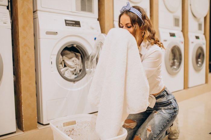 Young pretty woman at a laundrette