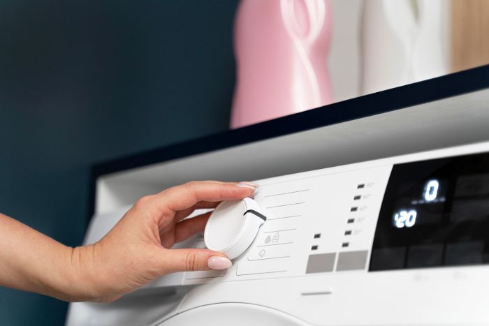 woman-choosing-program-washing-machine.jpg
