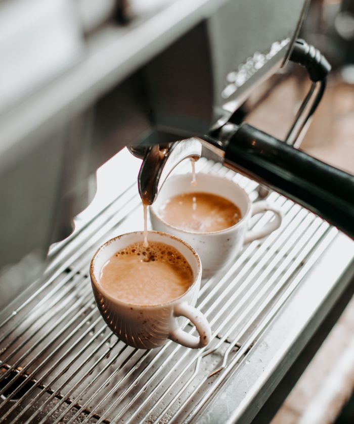 two espresso cups under coffee engine _