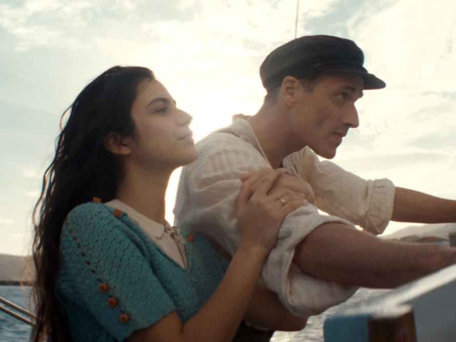 A man and a woman sailing on a boat at sea