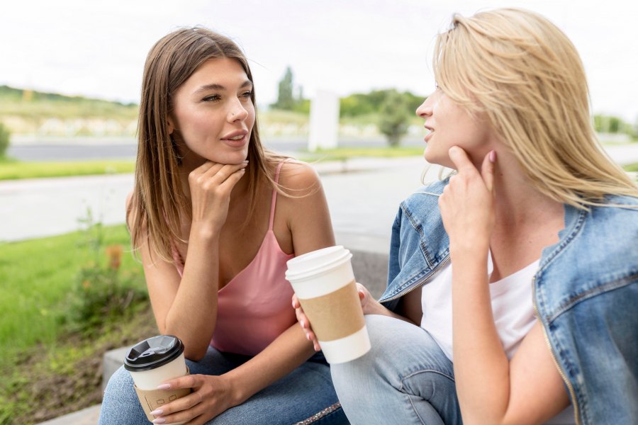 front-view-best-friends-holding-some-paper-cups-coffee.jpg