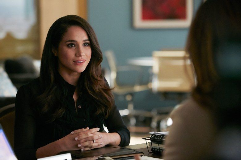 holding meghan markle suits