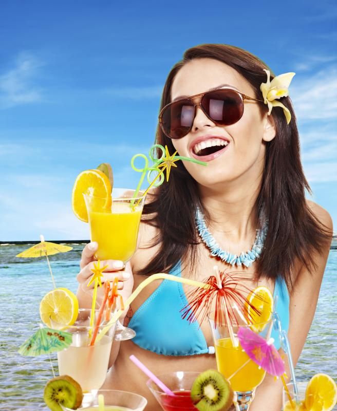 girl in bikini on beach drinking cocktail 1