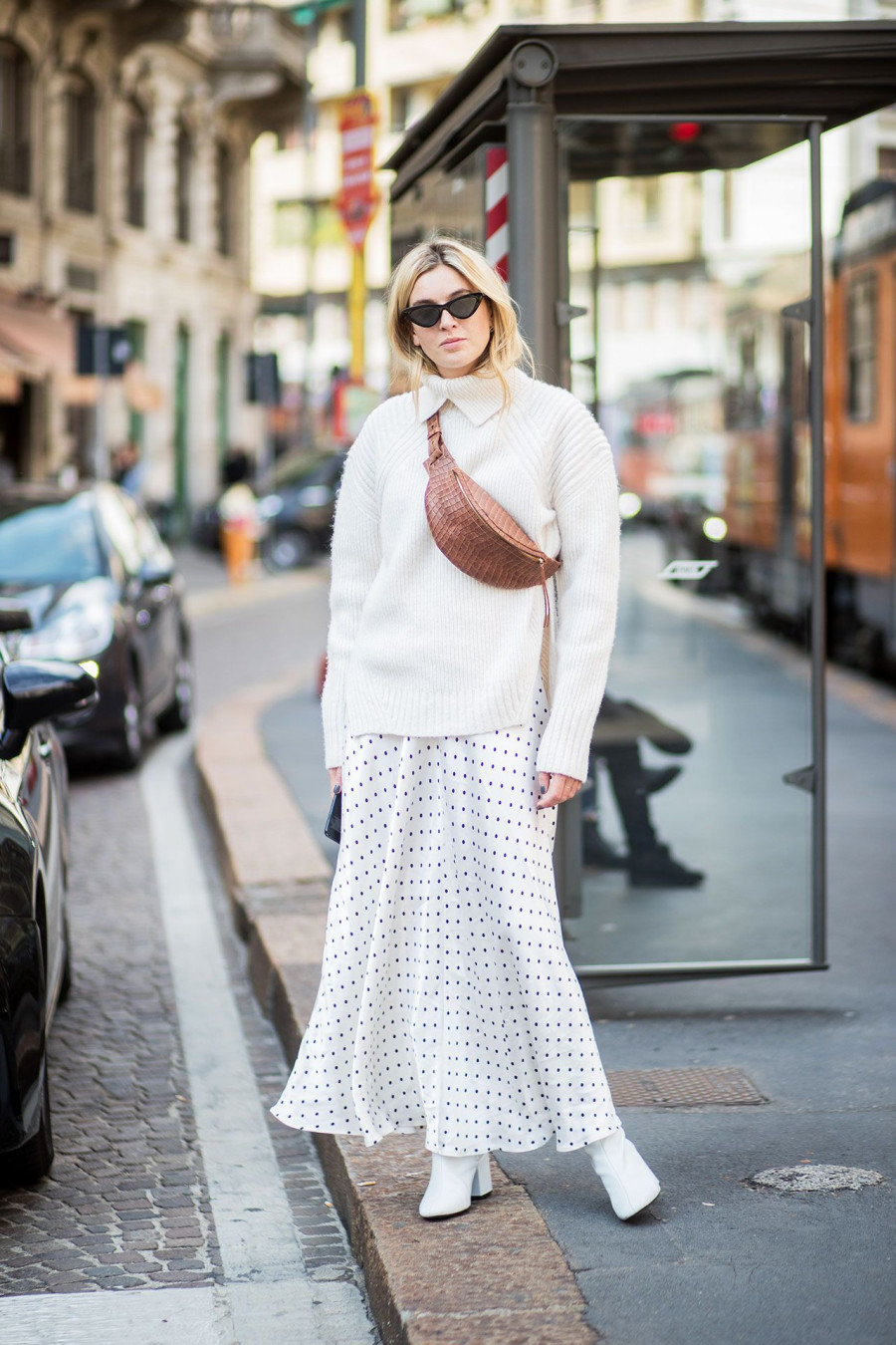 milan fashion week street style spring 2018 camille charriere white sweater white polka dot ganni dress white boots fanny pack belt bag