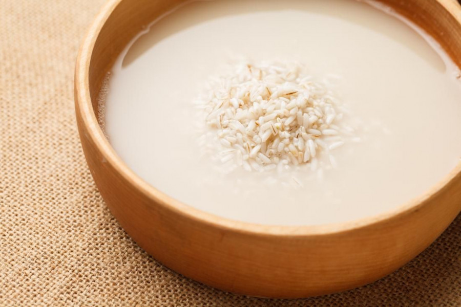 rice and rice water in a wooden bowl