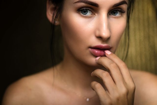 photo of woman holding lips 1204505