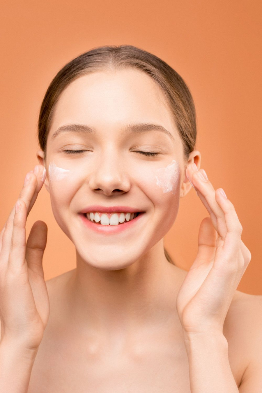 woman applying moisturizer on her face 3762890