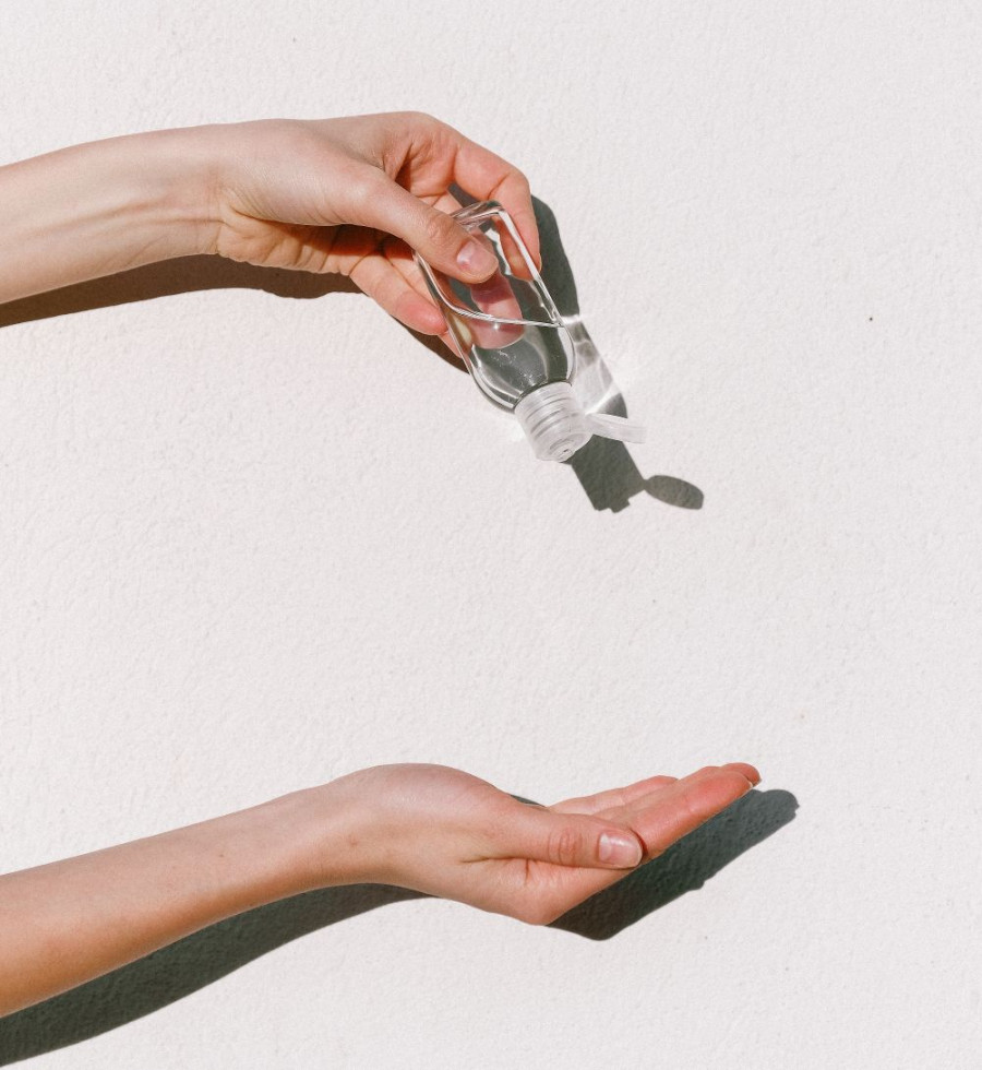 person holding hand sanitizer 3962332
