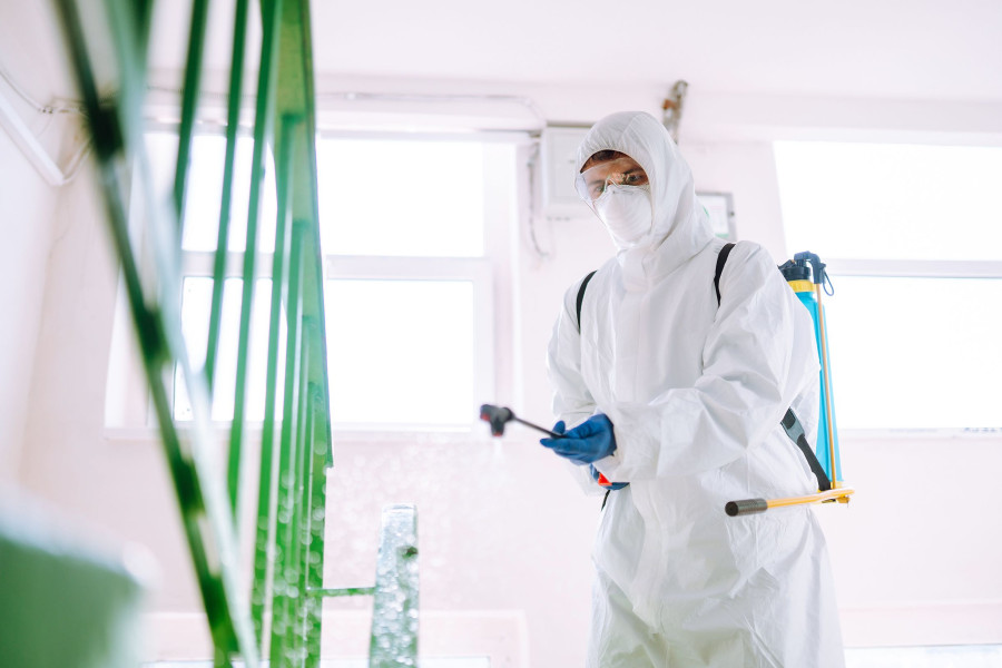 Man,In,Hazmat,Suit,,Protective,Gloves,And,Goggles,Use,Sprayer