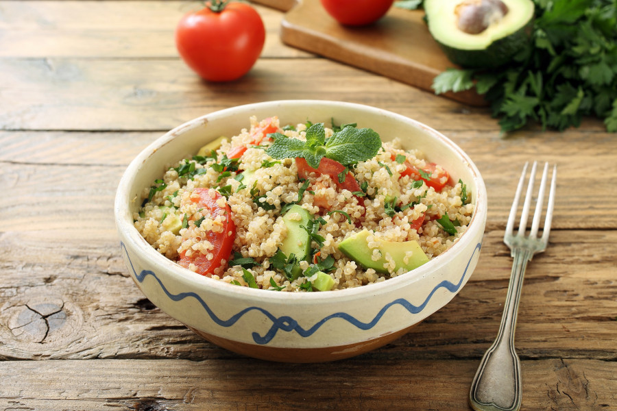 Quinoa,Vegetarian,Salad,Avocado,And,Tomato,On,Rustic,Kitchen,Table