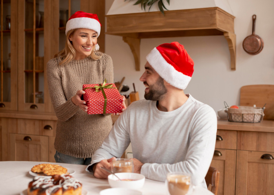 couple-wearing-christmas-hats-indoors.jpg