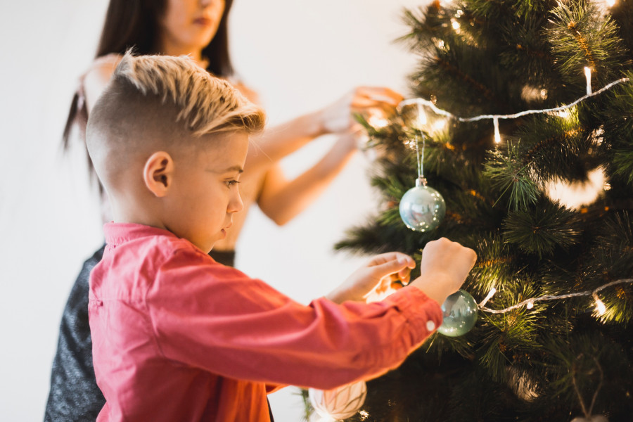 mother-boy-decorating-illuminated-christmas-tree.jpg