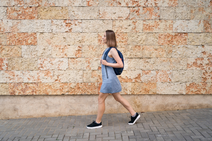 Young woman walking with backpack