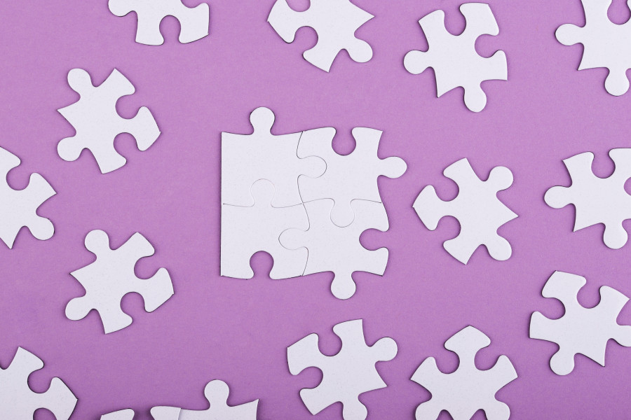flat-lay-white-puzzle-pieces-purple-background.jpg
