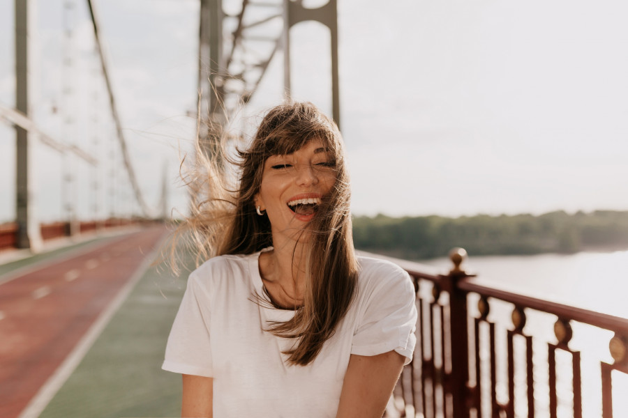 excited-laughing-woman-with-wonderful-smile-wearing-white-tshirt-if-closed-eyes-smiling-enjoying-morning-summer-walking-bridge-city.jpg