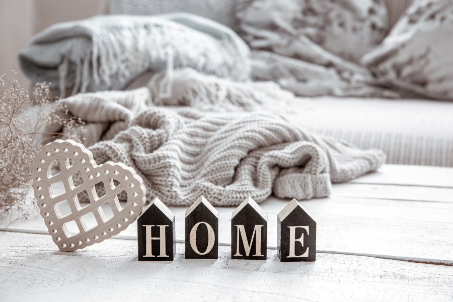 Cozy composition in Scandinavian style with decorative word home and decor details close up.