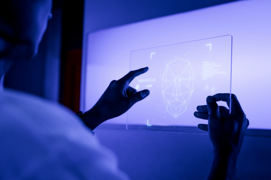 Designer using a transparent digital tablet screen futuristic te