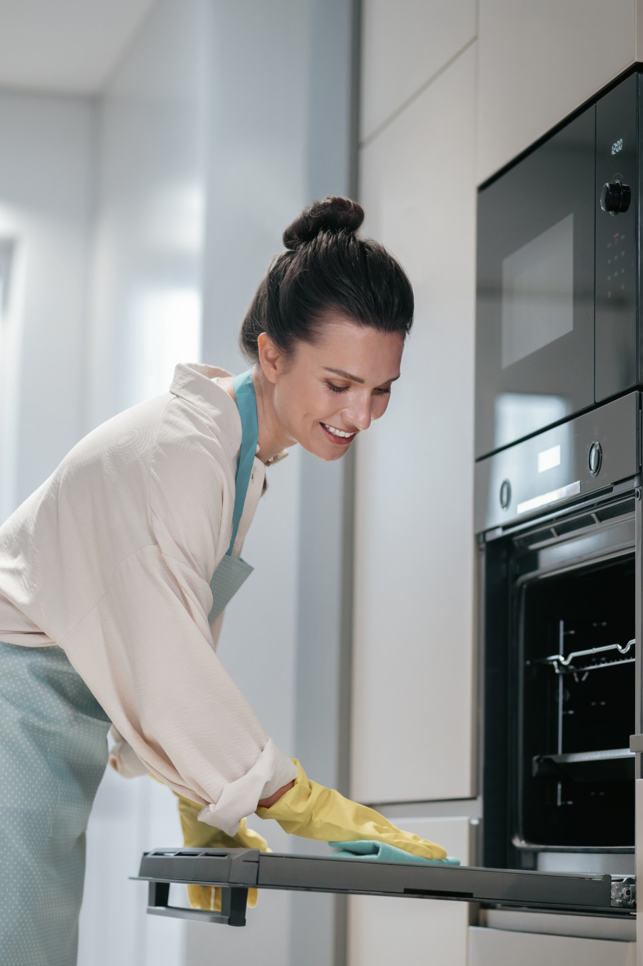 Service person cleaning the kitchen appliances