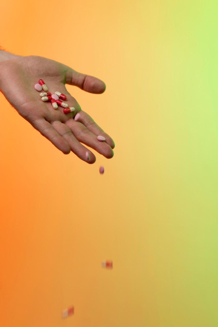 hands-holding-pills-gradient-background.jpg