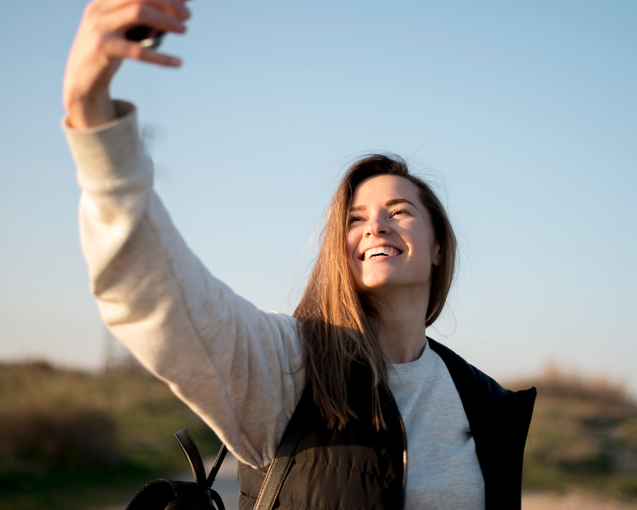 smiley-young-woman-taking-self-photo.jpg